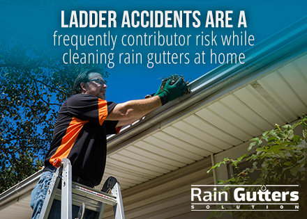  Man cleaning rain gutters at home 