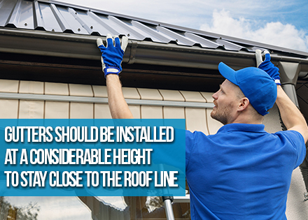 Gutter Installer With Metal Roof and Rain Gutters