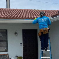 Contractor Installing Rain Gutters