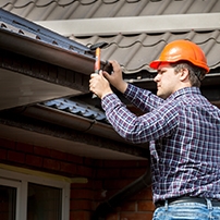 Man Repairing or Replacing a Gutter