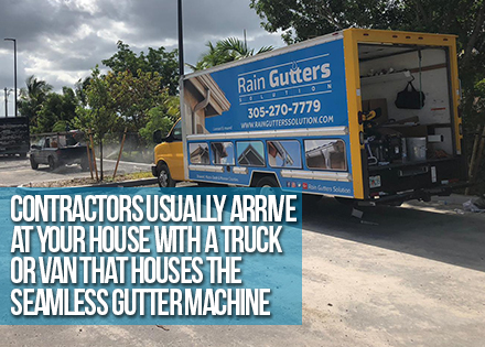 Gutter Machine on Truck in Front of a House