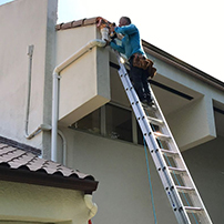 Man Installing a Custom Rain Gutters