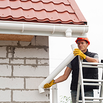 Man Installing One Downspout in a Gutter System