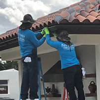 Two Men Installing a New Gutter System