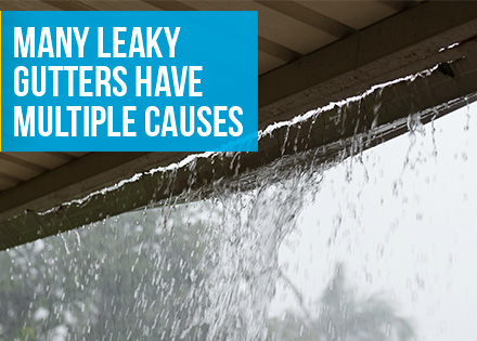 A Metal Gutter Leaking From the Bottom During a Rainstorm