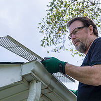 Technician Installing Metallic Mesh Gutter Guards