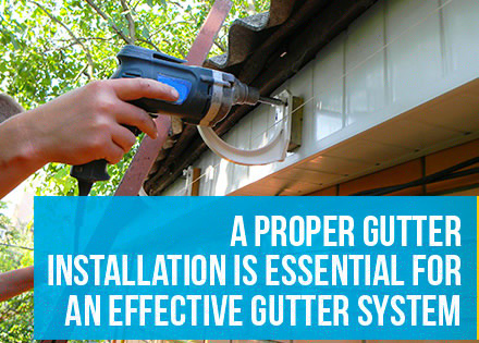 A Professional Gutter Installer Attaching a Rain Gutter to the Fascia Board