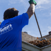 Man Cleaning a Rain Gutter