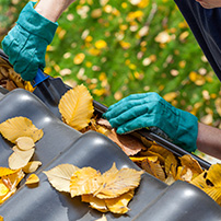 A Man Cleaning a Rain Gutter in Miami 